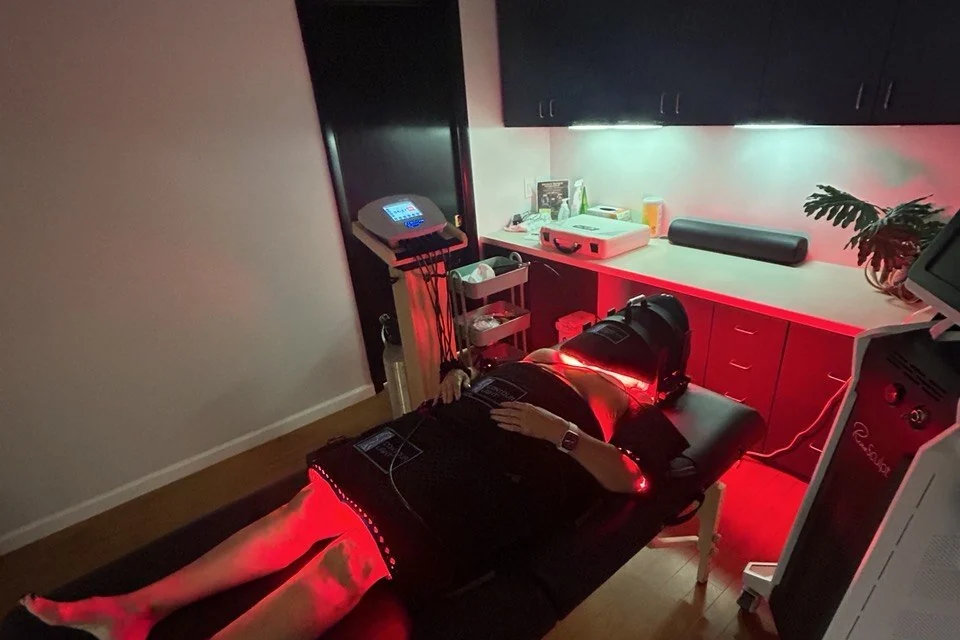 A client lying under the red light therapy pads at our Creve Coeur studio